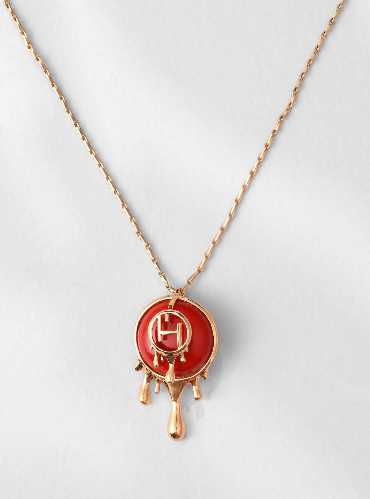 red designer pendant necklace in gold