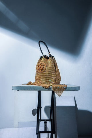 The Crystal Poppi Bucket Bag In Sculpted Gold