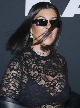 Kourtney Kardashian wearing stud earrings